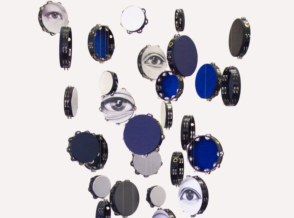 hanging tambourines with painted eyes