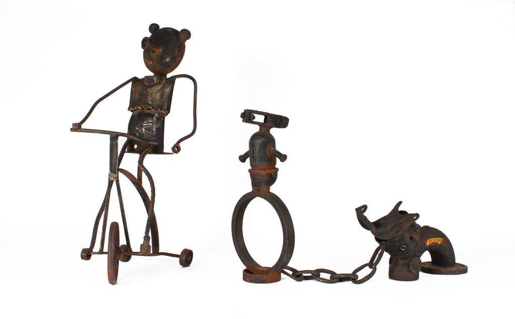 circus animals in bonds made from rusting steel